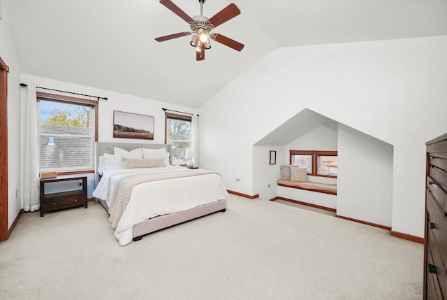 bedroom with light carpet, multiple windows, vaulted ceiling, and ceiling fan