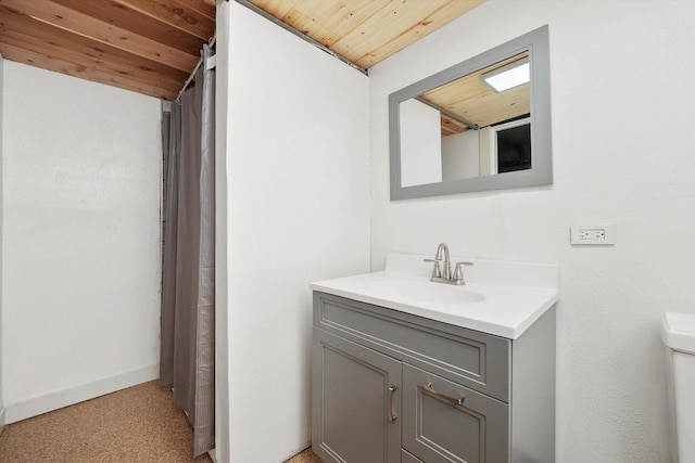 bathroom with vanity, lofted ceiling, and wooden ceiling