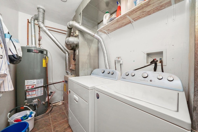 washroom with gas water heater and washer and dryer