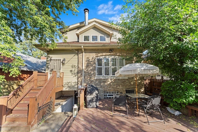 rear view of house with a wooden deck