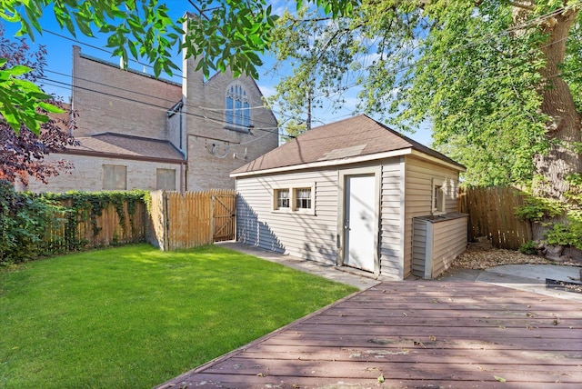 exterior space with a yard, a deck, and a storage shed