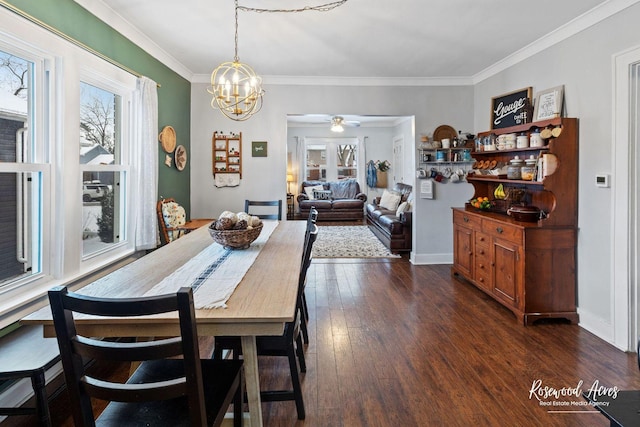 dining space featuring ceiling fan with notable chandelier, dark hardwood / wood-style floors, and ornamental molding