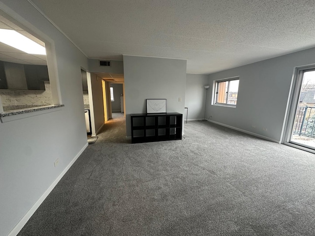 unfurnished room with dark carpet