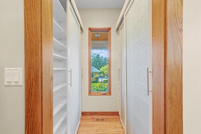 corridor with light wood-type flooring