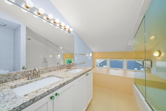 bathroom with tile patterned floors, vanity, and enclosed tub / shower combo