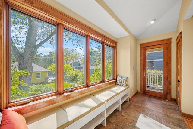 unfurnished sunroom featuring lofted ceiling and a wealth of natural light