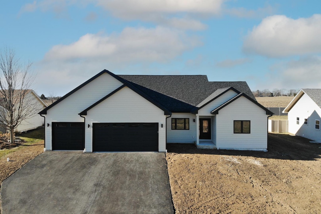 modern farmhouse featuring a garage