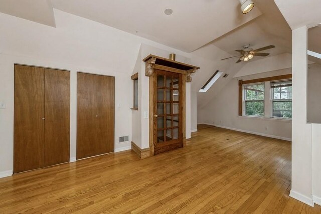 additional living space with ceiling fan and light wood-type flooring