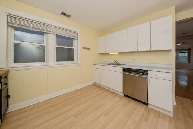 kitchen with light wood-type flooring, a sink, stainless steel dishwasher, white cabinetry, and light countertops