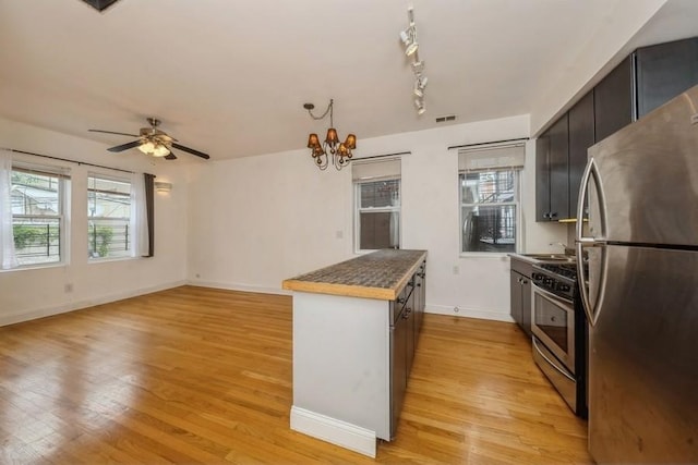 kitchen with visible vents, light wood-style flooring, stainless steel appliances, and a healthy amount of sunlight