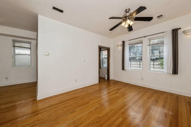 unfurnished room featuring hardwood / wood-style floors and ceiling fan