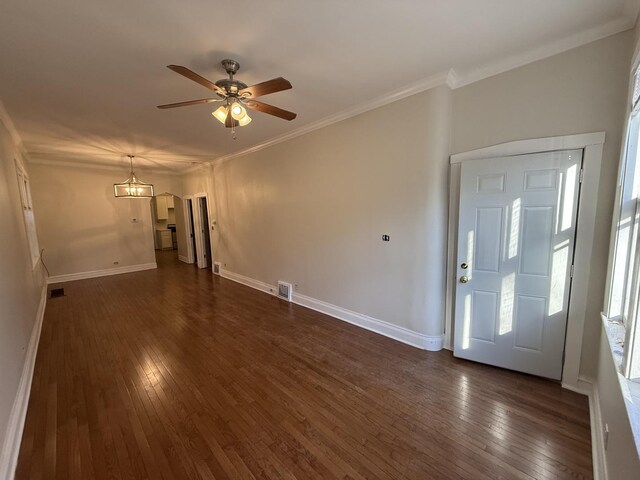 spare room featuring crown molding, dark hardwood / wood-style flooring, and ceiling fan