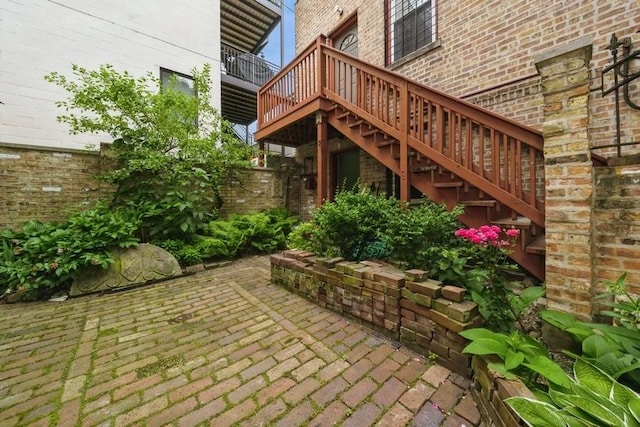 view of patio with stairs and fence