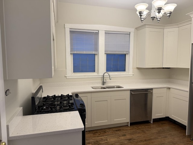 kitchen featuring black range with gas stovetop, dark wood finished floors, dishwasher, white cabinets, and a sink