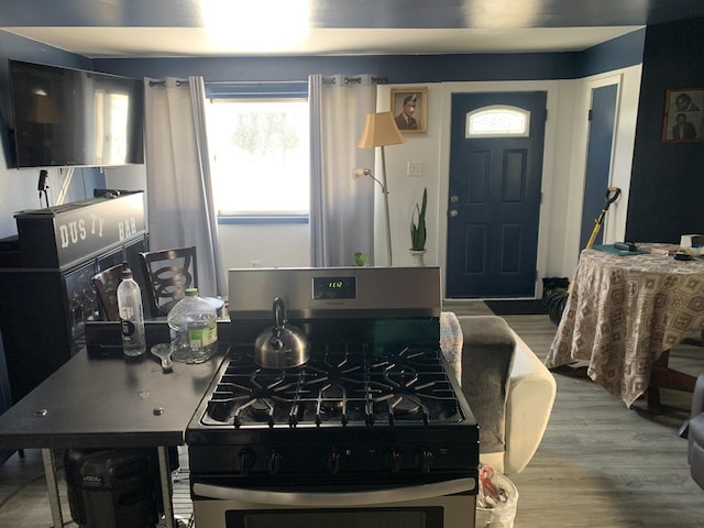 kitchen featuring hardwood / wood-style flooring and stainless steel range with gas stovetop