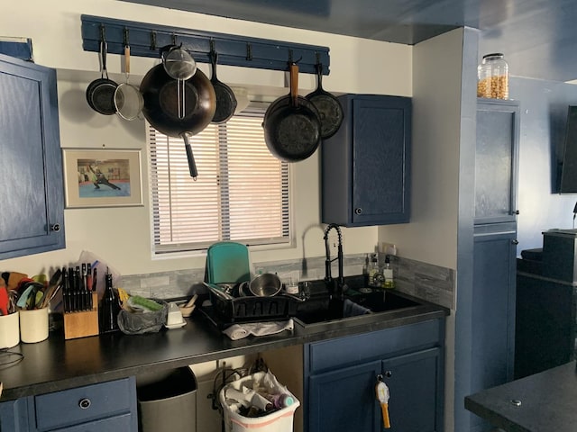 kitchen featuring sink and blue cabinetry