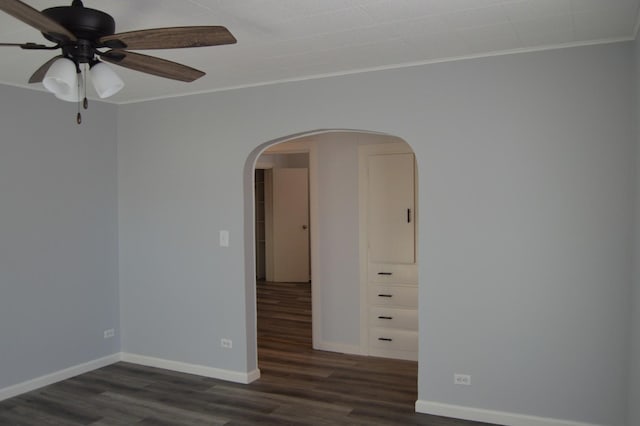 unfurnished room featuring ceiling fan, ornamental molding, and dark hardwood / wood-style floors