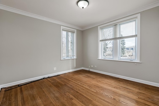 spare room featuring light hardwood / wood-style floors and ornamental molding