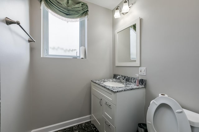 bathroom featuring vanity and toilet