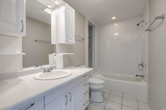 full bathroom featuring tiled shower / bath, tile patterned flooring, vanity, and toilet