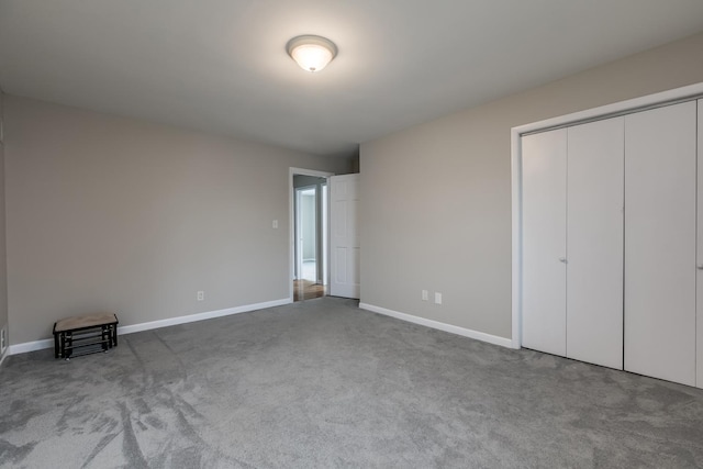 unfurnished bedroom with a closet and carpet floors