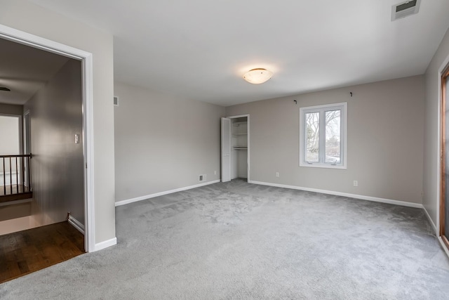 unfurnished bedroom with dark carpet