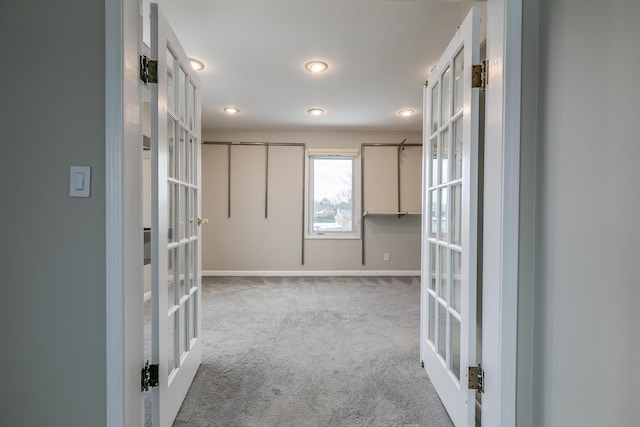 unfurnished room with light carpet and french doors