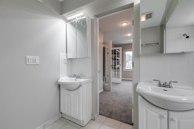 bathroom featuring backsplash, tile patterned flooring, and vanity