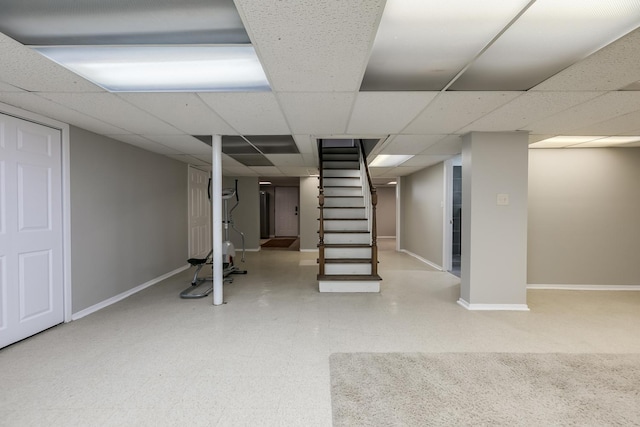 basement with a paneled ceiling