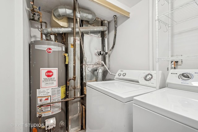 clothes washing area featuring separate washer and dryer and gas water heater