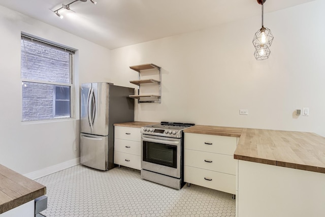 kitchen with pendant lighting, stainless steel appliances, white cabinetry, and butcher block counters