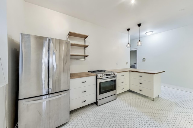 kitchen with wood counters, appliances with stainless steel finishes, kitchen peninsula, white cabinetry, and hanging light fixtures