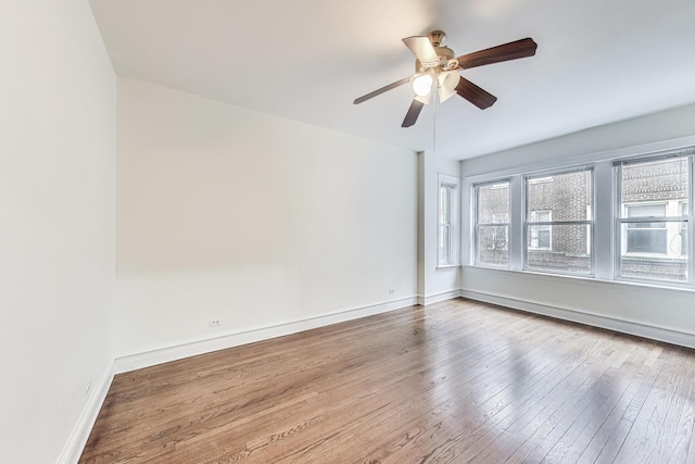 empty room featuring hardwood / wood-style floors and ceiling fan