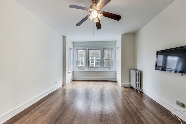 unfurnished living room featuring radiator heating unit, ceiling fan, and dark wood-type flooring