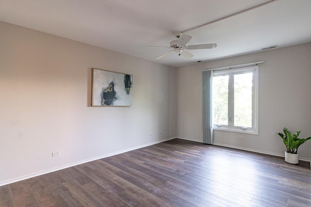 spare room featuring ceiling fan and dark hardwood / wood-style flooring