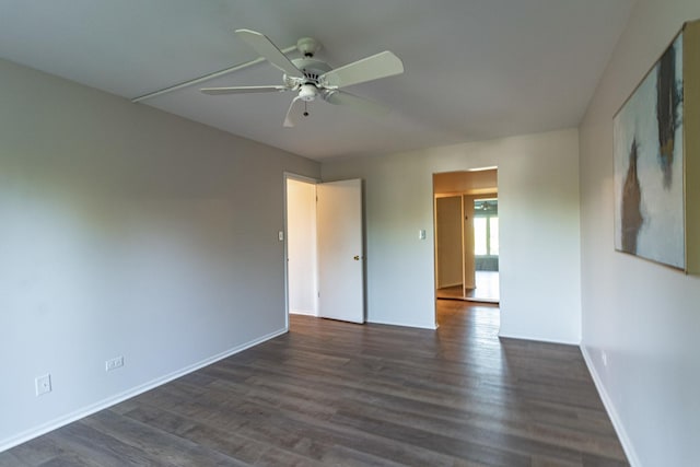 unfurnished room with ceiling fan and dark hardwood / wood-style flooring