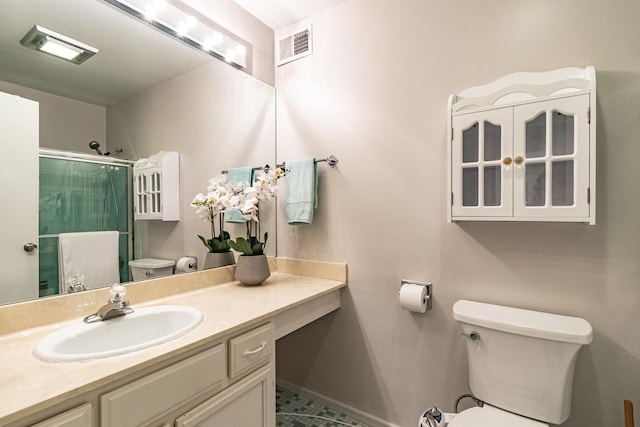 bathroom featuring vanity, toilet, and walk in shower