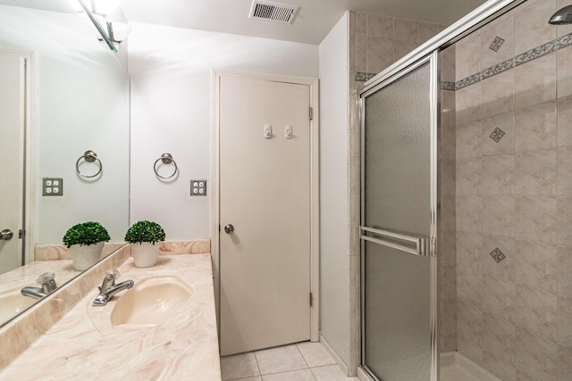 bathroom featuring vanity, tile patterned floors, and an enclosed shower