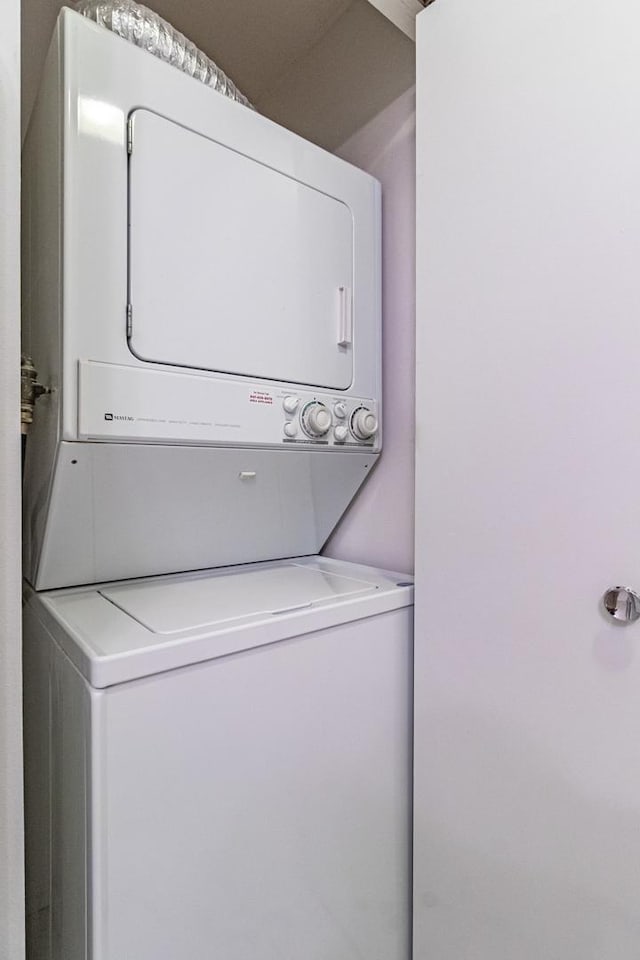 laundry room with stacked washer and dryer