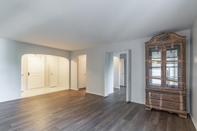 unfurnished room featuring dark wood-type flooring