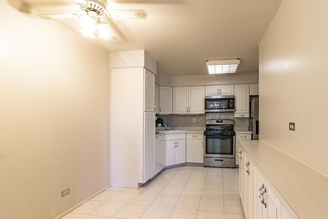 kitchen featuring light tile patterned flooring, ceiling fan, white cabinets, and stainless steel appliances