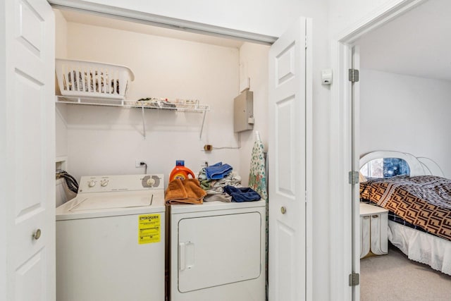 clothes washing area with washer and dryer and carpet floors