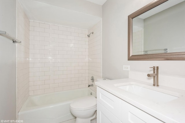 full bathroom featuring vanity, toilet, and tiled shower / bath