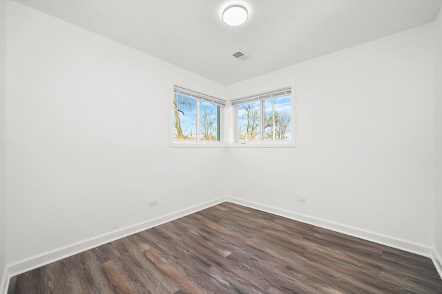 empty room with dark wood-type flooring