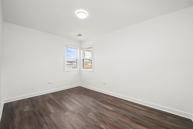 spare room featuring dark hardwood / wood-style flooring