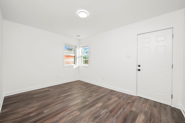 empty room with dark wood-type flooring