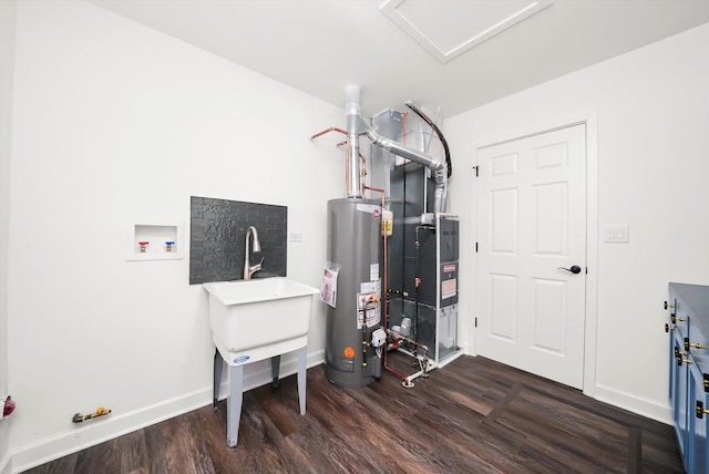 utility room with gas water heater, heating unit, and sink