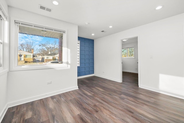 unfurnished room with dark wood-type flooring