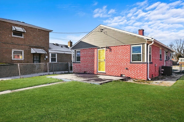 back of house featuring a patio area, a yard, and central AC unit