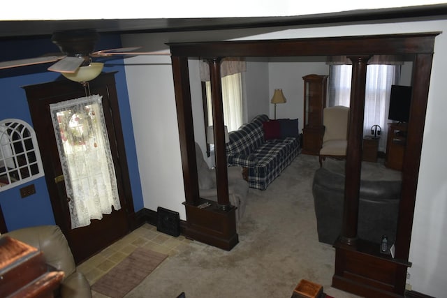 carpeted living room featuring decorative columns, ceiling fan, and plenty of natural light